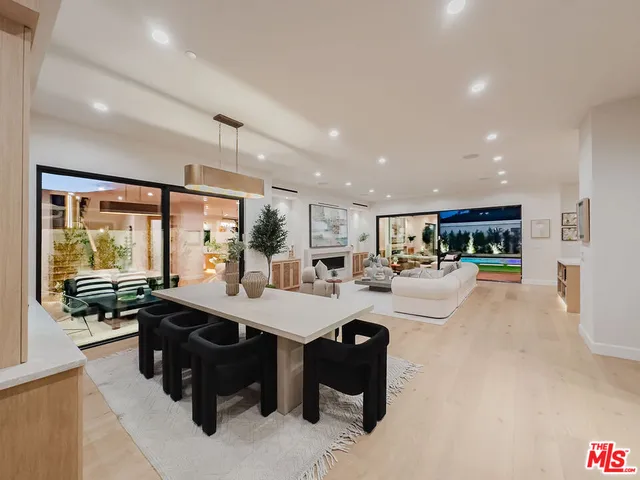 a room with wooden floor and large windows