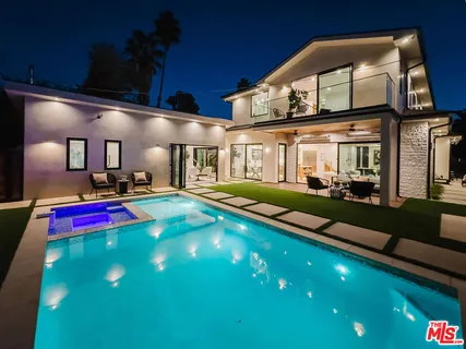 a swimming pool with outdoor seating