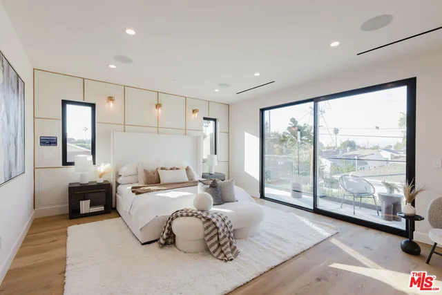 a living room with furniture and large windows