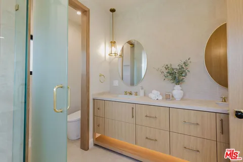 a bathroom with a double vanity sink and a mirror