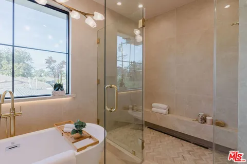 a bathroom with a tub a toilet and a shower