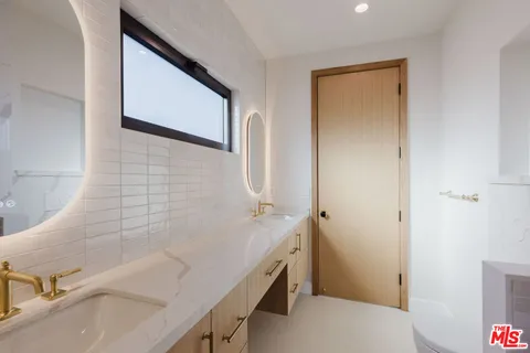 a bathroom with a sink and a large mirror