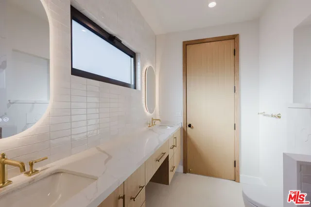 a bathroom with a sink and a large mirror
