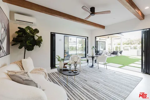 a living room with furniture and a floor to ceiling window