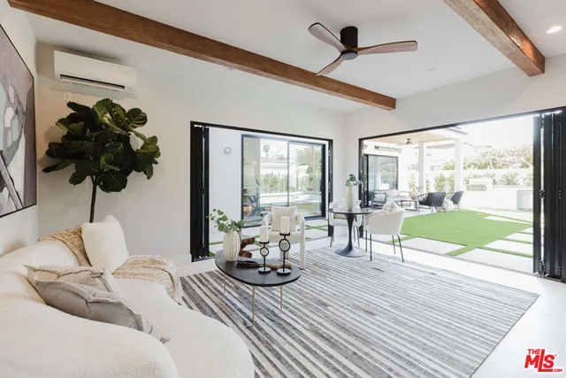 a living room with furniture and a floor to ceiling window