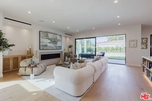 a living room with furniture large window and a flat screen tv