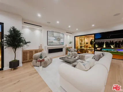 a living room with furniture a table and a potted plant