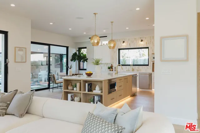 a living room with furniture and a large mirror