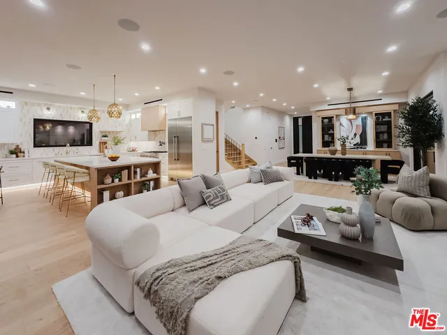 a large bedroom with a bed a table and chairs