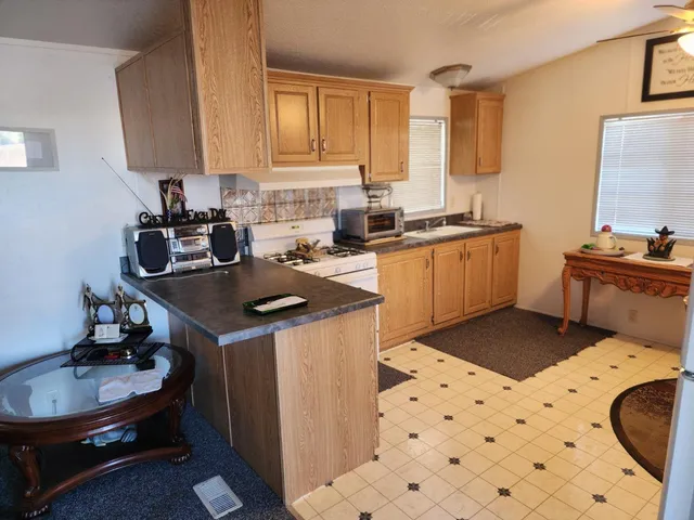 a kitchen with a sink and a stove top oven