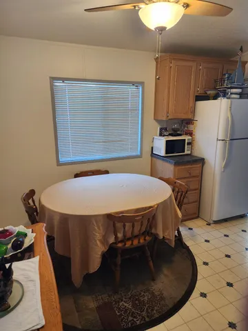 a dining room with a table chairs and entryway