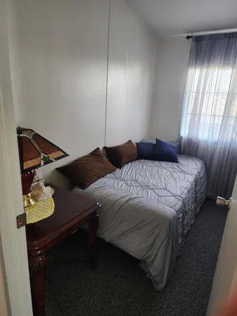 a bedroom with a bed and window
