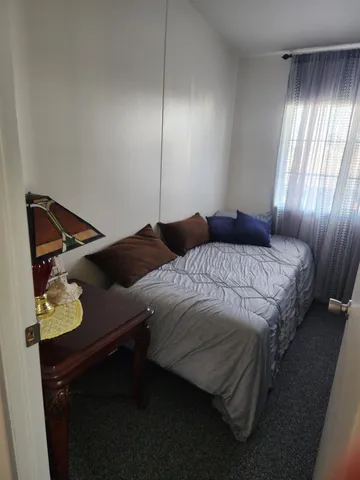 a bedroom with a bed and window