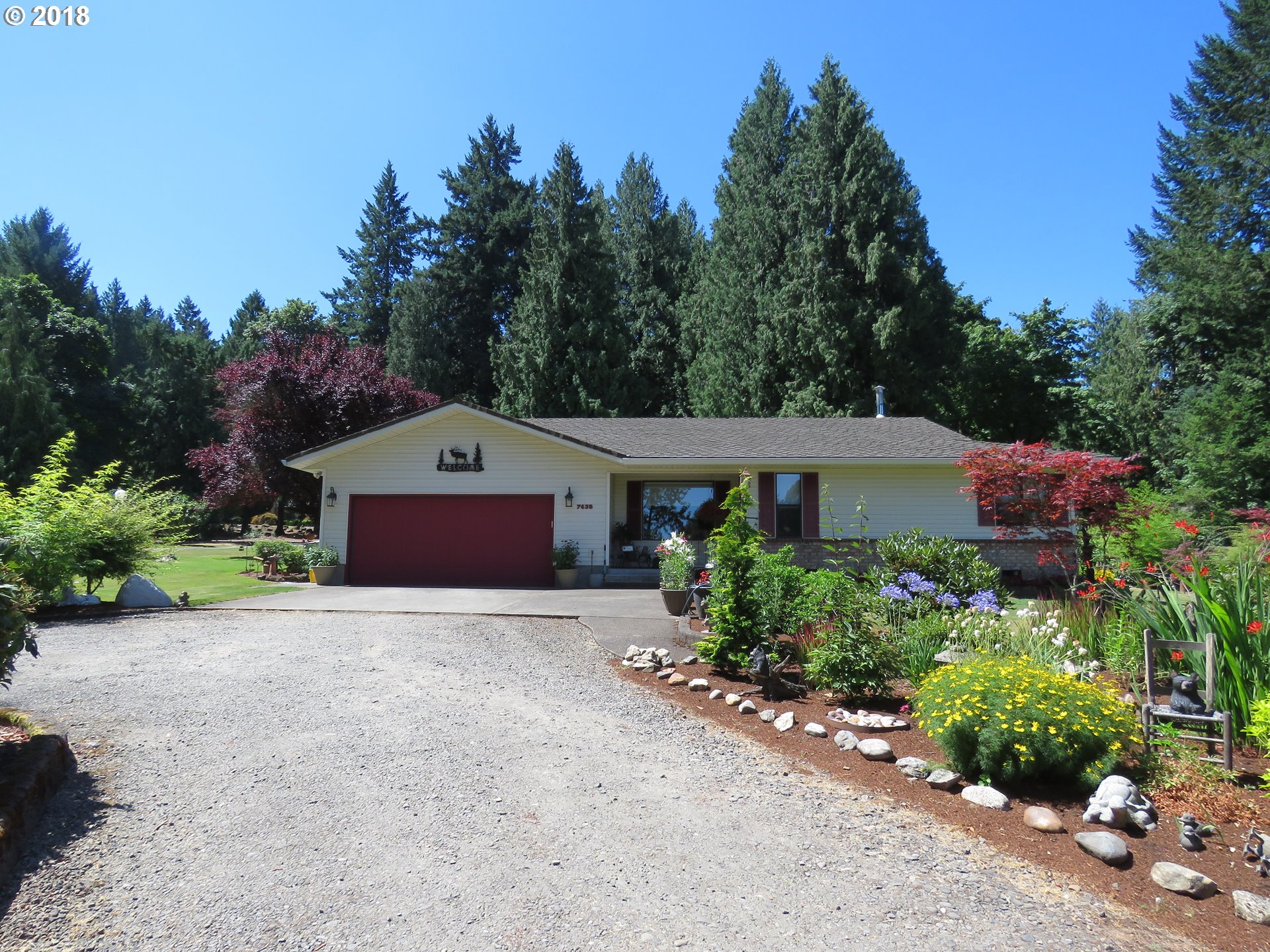7635 Southeast Barbara Welch Road Portland, OR 97236 - Photo 1 of 26 a house view with a garden space