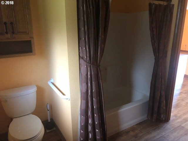 7635 Southeast Barbara Welch Road Portland, OR 97236 - Photo 11 of 26 a bathroom with a toilet and a shower