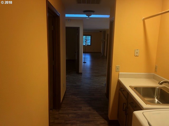 7635 Southeast Barbara Welch Road Portland, OR 97236 - Photo 14 of 26 a view of a hallway with wooden floor and a bathroom