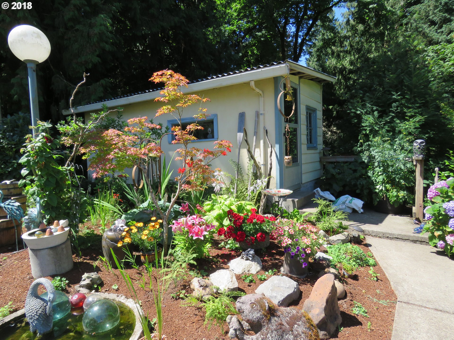 7635 Southeast Barbara Welch Road Portland, OR 97236 - Photo 16 of 26 a front view of a house with a yard and a fountain