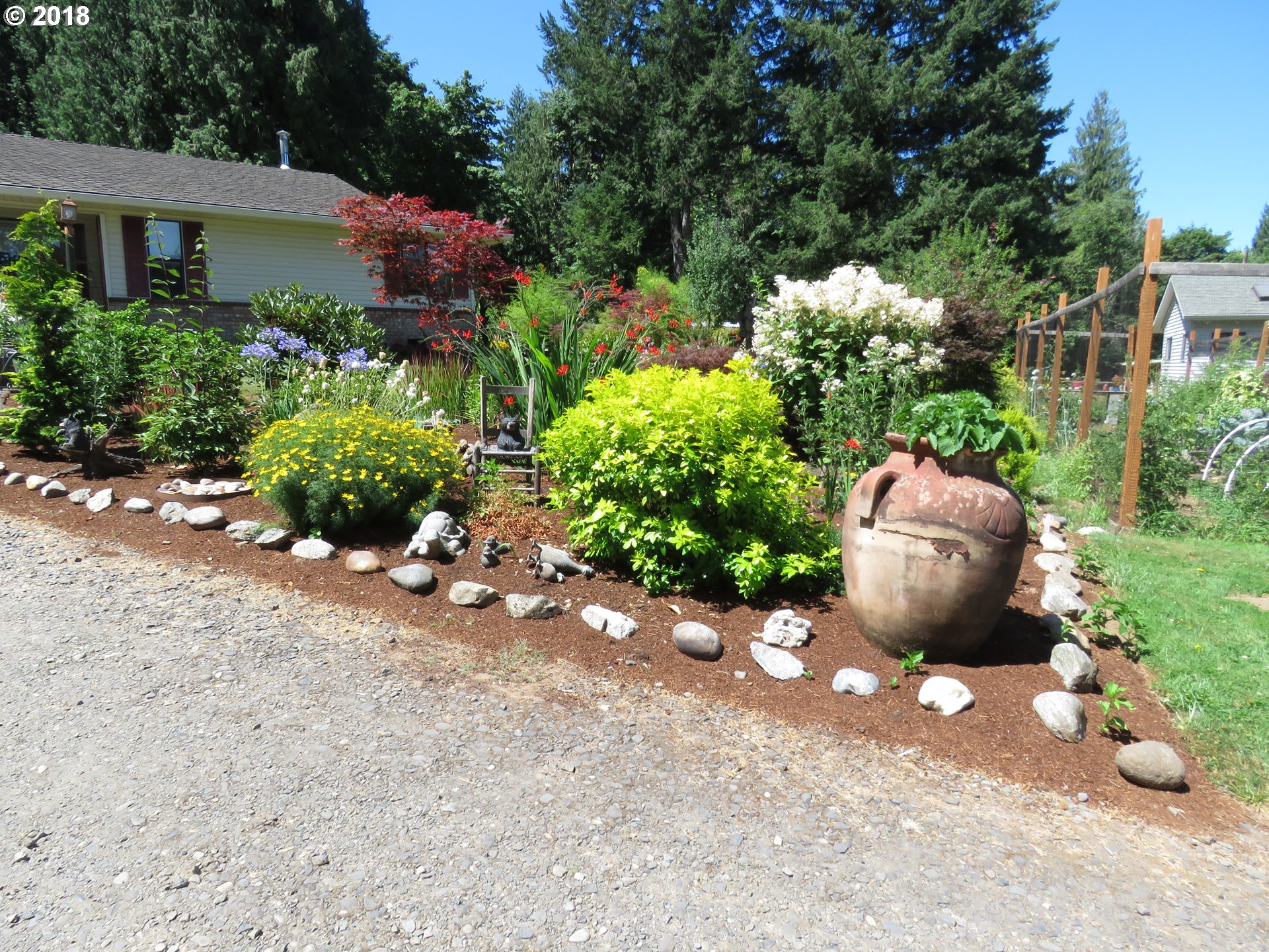 7635 Southeast Barbara Welch Road Portland, OR 97236 - Photo 2 of 26 a view of a backyard with table and chairs and potted plants