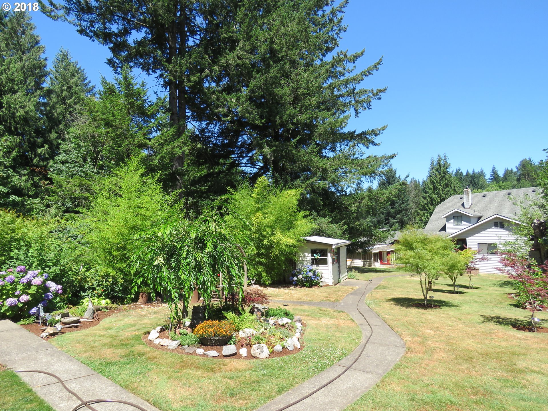 7635 Southeast Barbara Welch Road Portland, OR 97236 - Photo 21 of 26 a swimming pool with lots of tress in the background