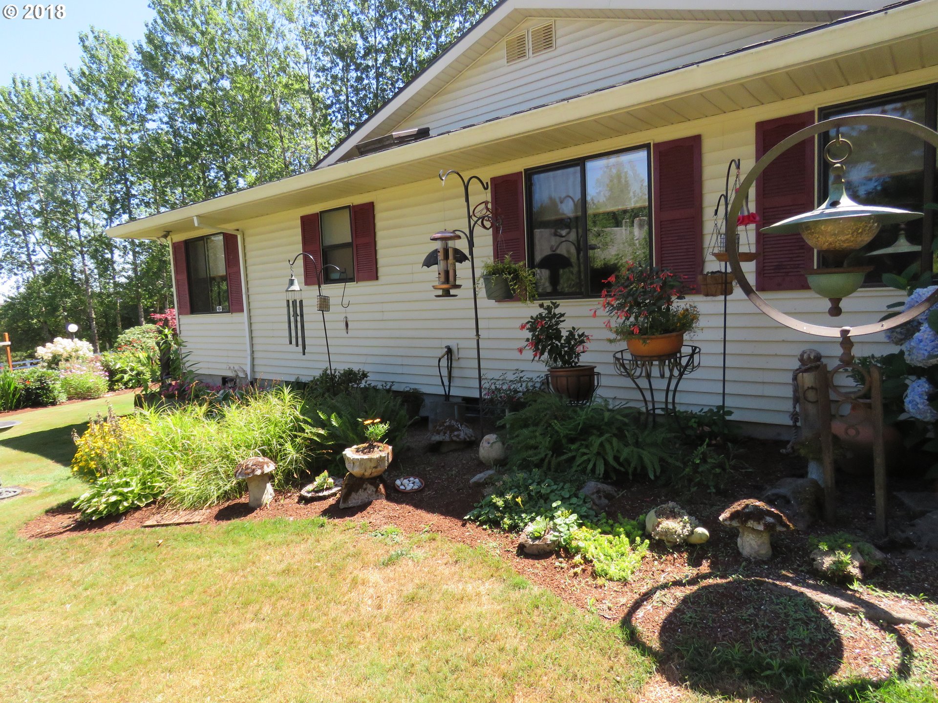 7635 Southeast Barbara Welch Road Portland, OR 97236 - Photo 22 of 26 a backyard of a house with yard fire pit and outdoor seating