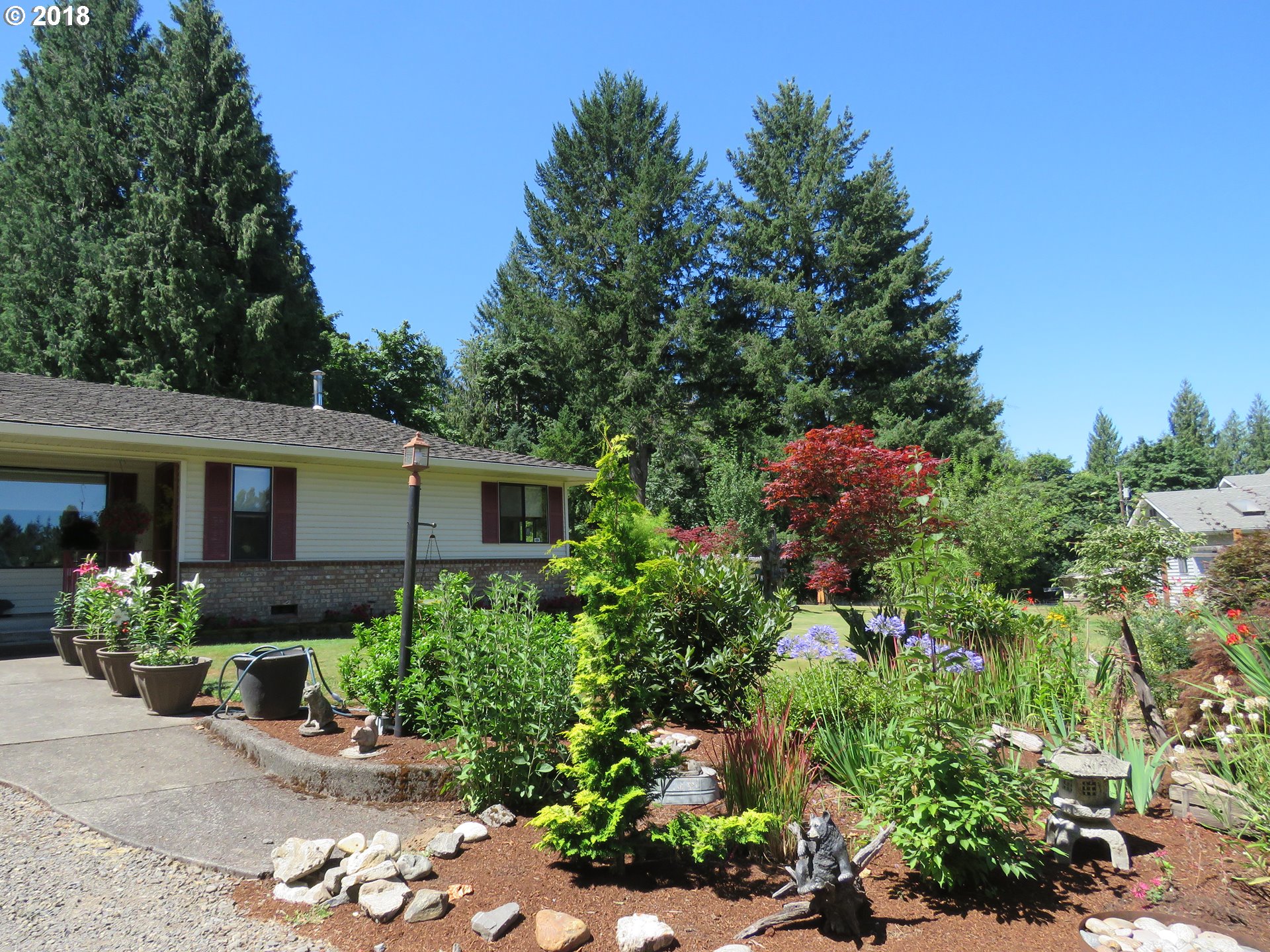 7635 Southeast Barbara Welch Road Portland, OR 97236 - Photo 24 of 26 a front view of a house with a yard