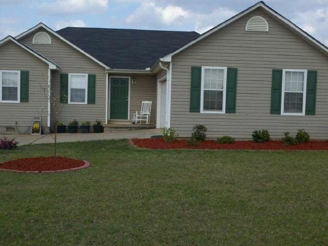 a front view of a house with a garden