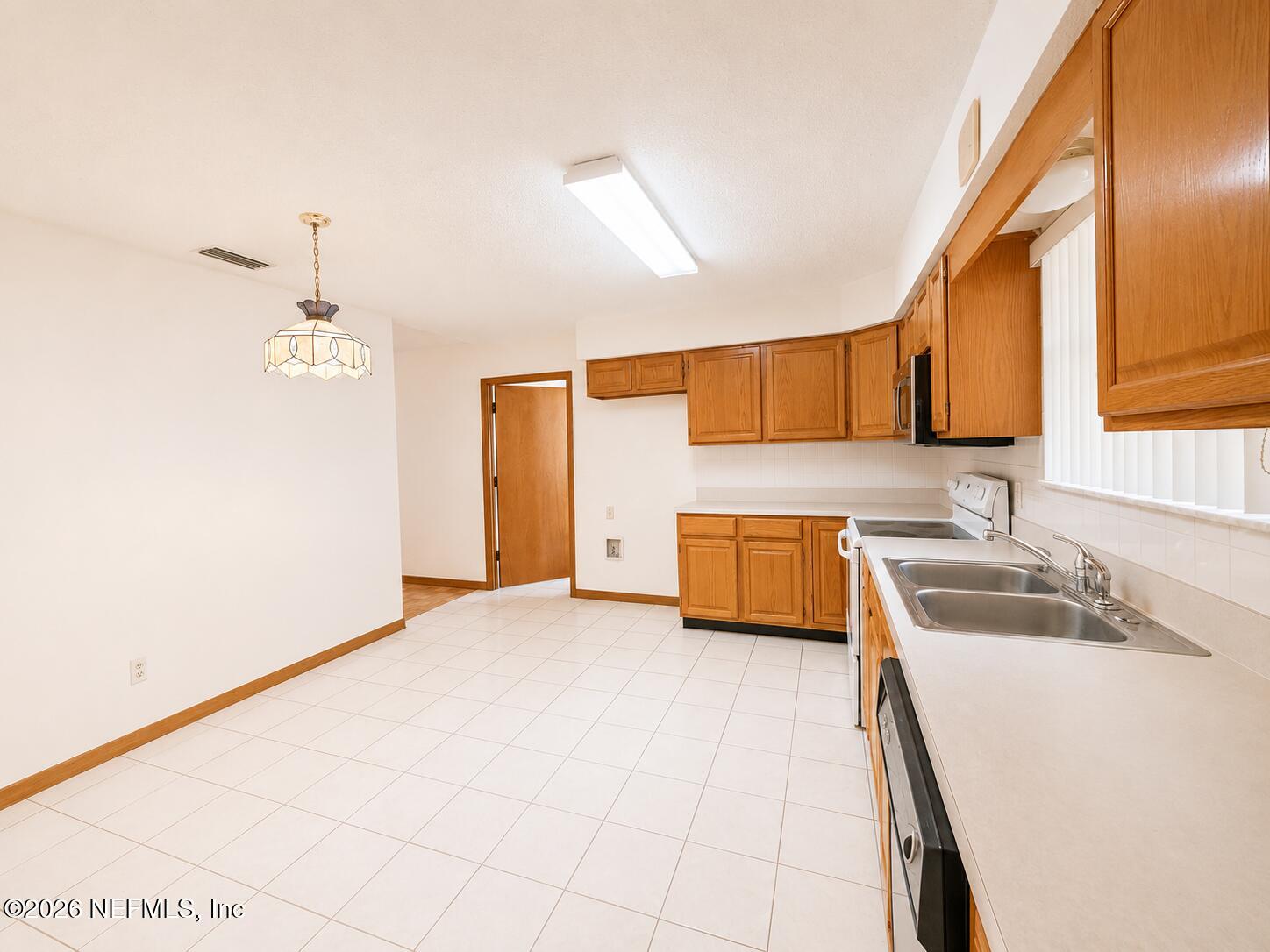 6 Surfcrest Street St. Augustine Beach, FL 32080 - Photo 6 of 15 a kitchen with a sink a stove and cabinets