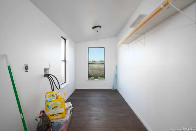 a view of a hallway to a livingroom with furniture