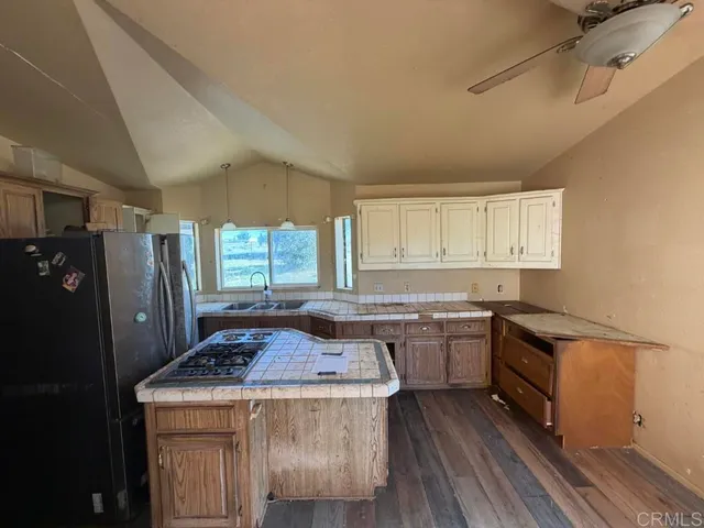 a kitchen with a stove a sink and a refrigerator