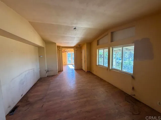 a view of a livingroom with wooden floor and windows