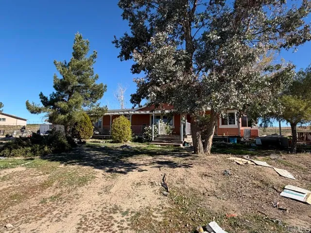 a view of a house with a yard covered in snow