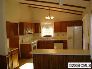 9617 Riddick Place Matthews, NC 28105 - Photo 4 of 8 a kitchen with a refrigerator and a sink