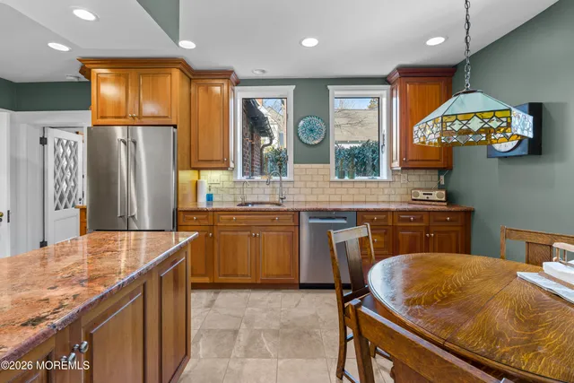 a kitchen with granite countertop a sink and a stove