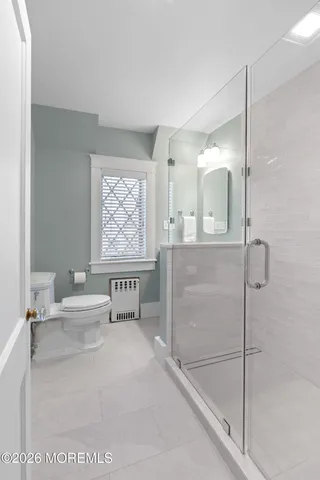a bathroom with a shower and a sink