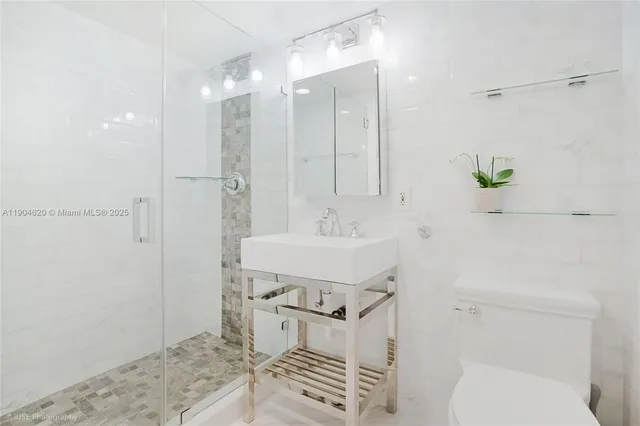 a bathroom with a sink toilet and shower