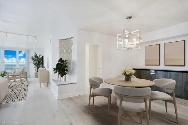a view of a dining room with furniture and chandelier