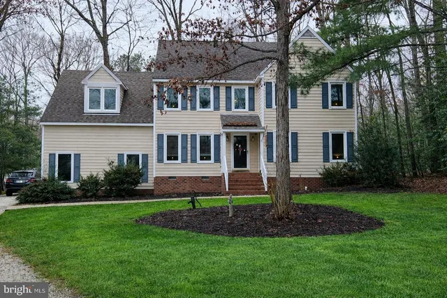 a view of a chair and table in backyard of the house