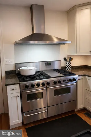 a kitchen with granite countertop a refrigerator and a sink