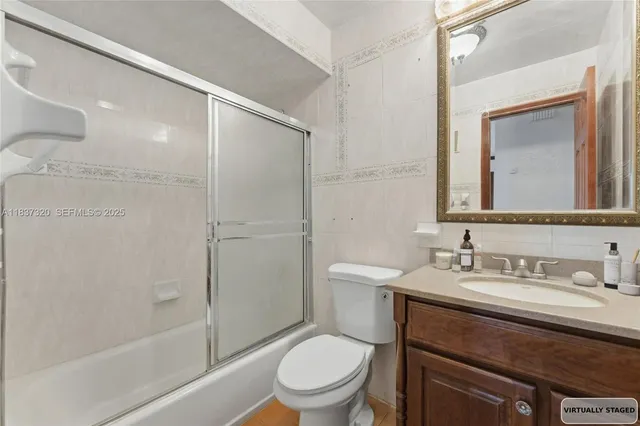a bathroom with a toilet a sink a mirror a bathtub and shower