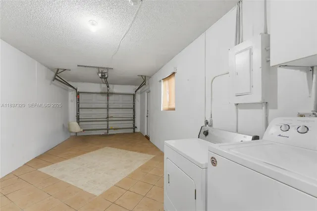 a room with a washing machine and a sink