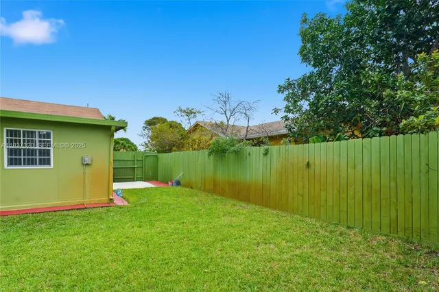 a view of an house with backyard space and garden