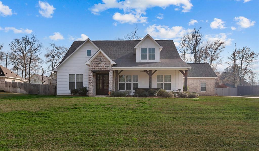 550 Ramsey Road Stonewall, LA 71078 - Photo 2 of 40 a front view of a house with a garden