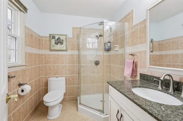 a bathroom with a granite countertop toilet sink and shower
