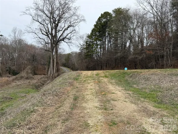 a swimming pool with trees in the background