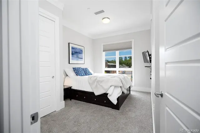 a bed room with a bed and a window