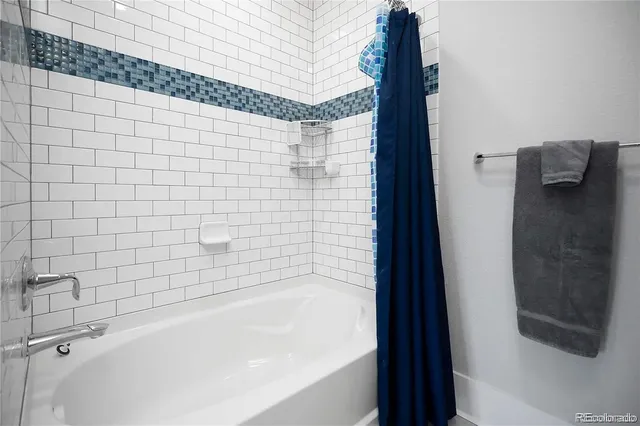 a bathroom with a bathtub and shower