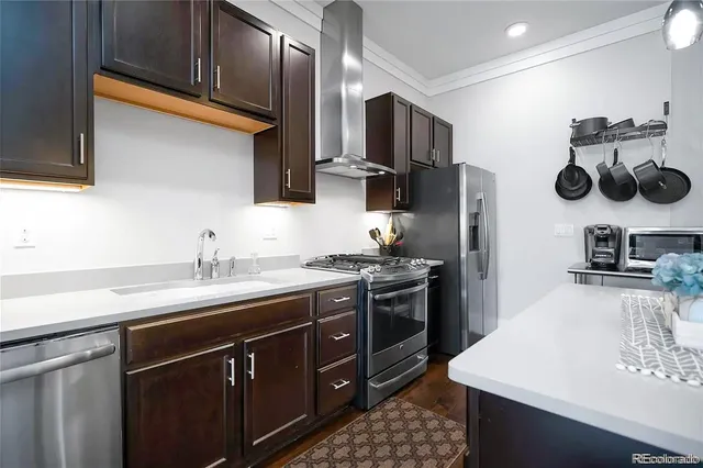 a kitchen with a sink a stove and cabinets