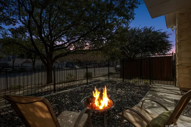 a backyard of a house with table and chairs
