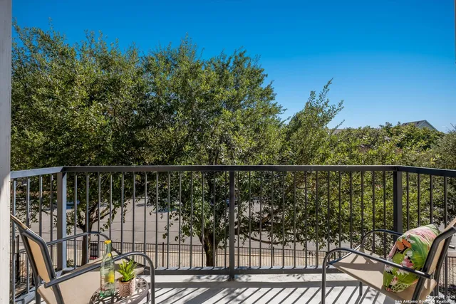 a view of a balcony with wooden floor and outdoor seating