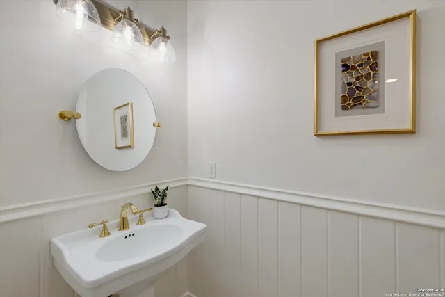 a bathroom with a sink mirror and vanity